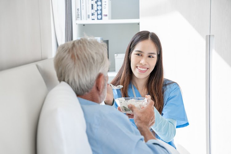 Medical staff taking and caregiver senior man in Home. Home care concept.
